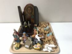 A tray of hand painted folding religious icon, plastic nativity set, brass cannon,
