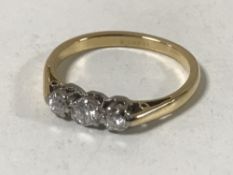 An 18ct gold three stone diamond ring