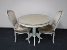 A contemporary French shabby chic table with two chairs