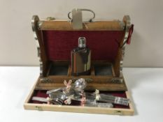 An oak three bottle Tantalus with key (no decanters),