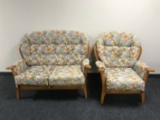A two-piece wood framed cottage suite upholstered in a floral buttoned fabric