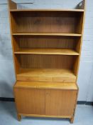 A set of Danish teak open shelves with cupboards beneath