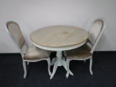 A contemporary French shabby chic table with two chairs