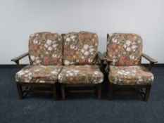 A mid 20th century oak framed armchair together with twin section settee
