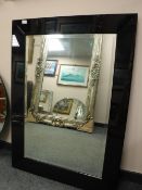 A contemporary two tone glass mirror,