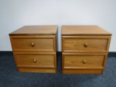 A pair of teak two drawer bedside chests