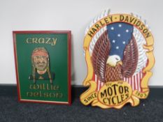 A wooden Harley Davidson sign together with a Crazy Willie Nelson plaque