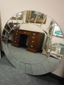 A contemporary all glass oval mirror 93cm x 107cm