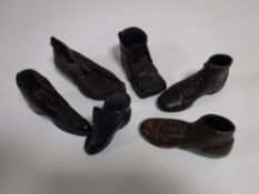 A box containing an antique miniature leather shoe and five ornamental shoes