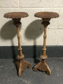 A pair of cast iron garden candlesticks