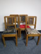 A set of four carved oak Edwardian dining chairs