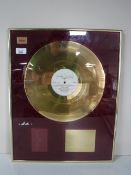 A framed gold disk presented to I.
