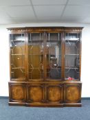 A mahogany Regency style breakfront four door bookcase fitted cupboards beneath CONDITION