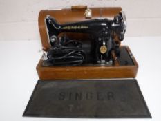 A mid 20th century oak cased Singer sewing machine (electrified)