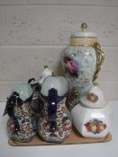 A tray containing three graduated ironstone jugs, gilded wall plates,