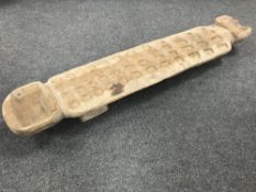 A carved African gaming board.