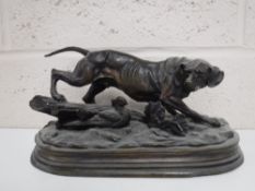 A spelter figure of a gun dog signed E.