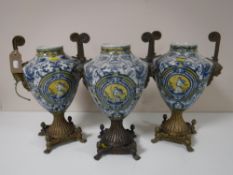 A trio of ormolu mounted blue and white decorative urns