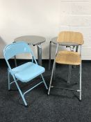 Two circular metal cafe tables together with two folding chairs