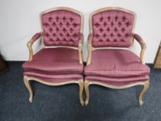 A pair of French style armchairs in a plum button fabric
