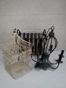 A wrought iron and leather magazine rack together with a six way metal light fitting and a metal