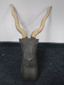 A contemporary wooden antelope head with wicker antlers