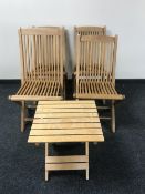 A set of four plantation teak folding garden chairs together with a folding occasional table
