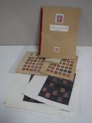A collection of antique stamps in books and slip covers including many penny reds