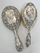 A sterling silver backed hair brush and matching hand mirror