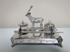 An early twentieth century plated desk stand surmounted with a stag