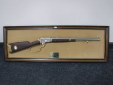 A replica John Wayne model 44-40 rifle 1892 mounted on board