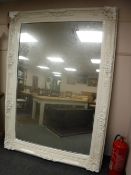 A large white ornate mirror,