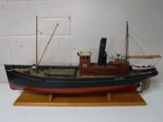 A remote control model boat on wooden stand 'Iris,