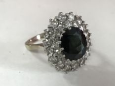 An 18ct gold sapphire and diamond cluster ring, approximately 1.6ct, size M.