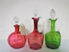 Three antique coloured glass decanters