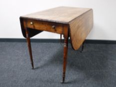 A George III mahogany drop leaf sofa table, on tapered legs terminating in brass castors,