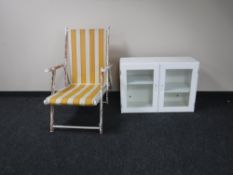 A mid 20th century painted deck chair together with a glazed double door wall cabinet