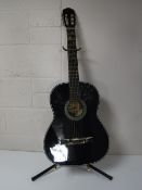 A classical acoustic guitar on stand