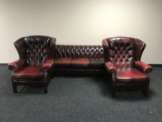 A four piece red buttoned leather Chesterfield style suite comprising of three seater club settee,
