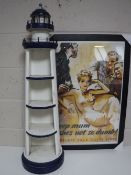 A set of wooden shelves in the form of a lighthouse together with a reproduction framed propaganda
