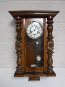 An early 20th century mahogany cased eight day wall clock with enamelled dial