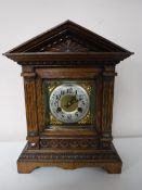 An early twentieth century carved oak cased bracket clock