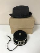A bell boy's hat bearing number 162 together with a boxed trilby retailed by Christie's of London