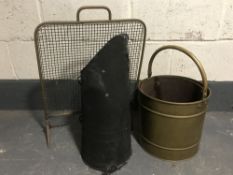 An antique brass coal bucket with liner together with one other coal bucket and a brass spark guard