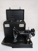 An early 20th century cased Singer miniature sewing machine