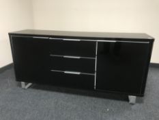 A contemporary black high gloss sideboard