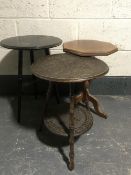 An oak poker work two tier occasional table together with one other occasional table and a plant
