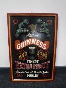 A wooden Guinness Finest Extra Stout sign