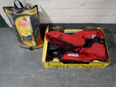 A box containing Seago & Sigma inflatable life vests