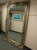 A large silvered ornate mirror,
